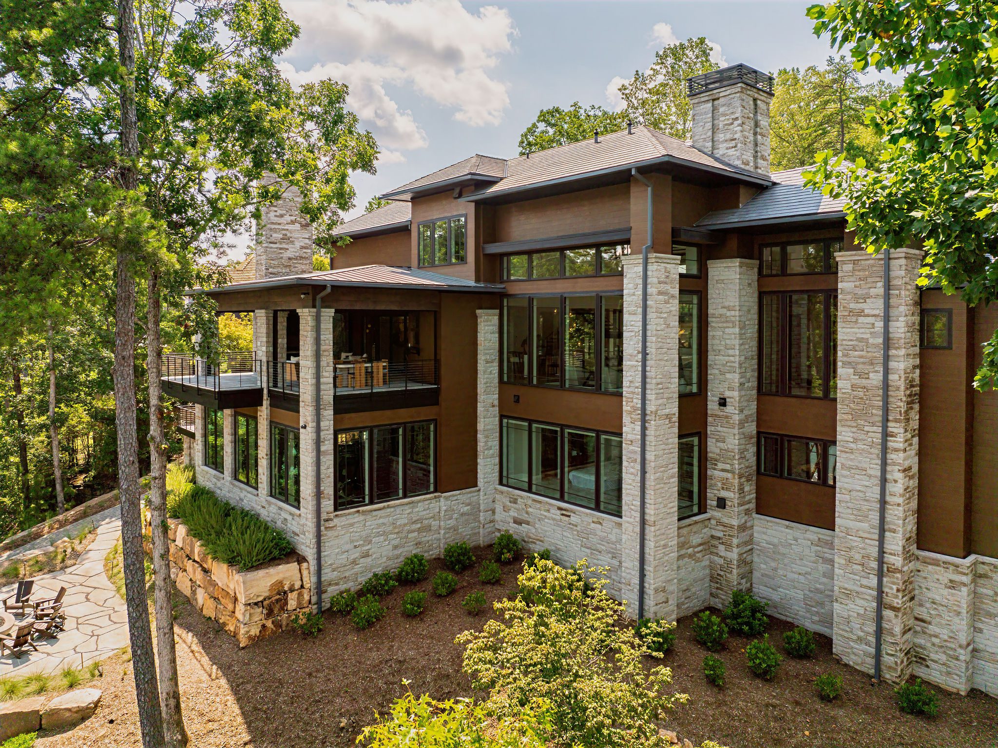 Gabriel Builders luxury lakefront home exterior with stone siding
