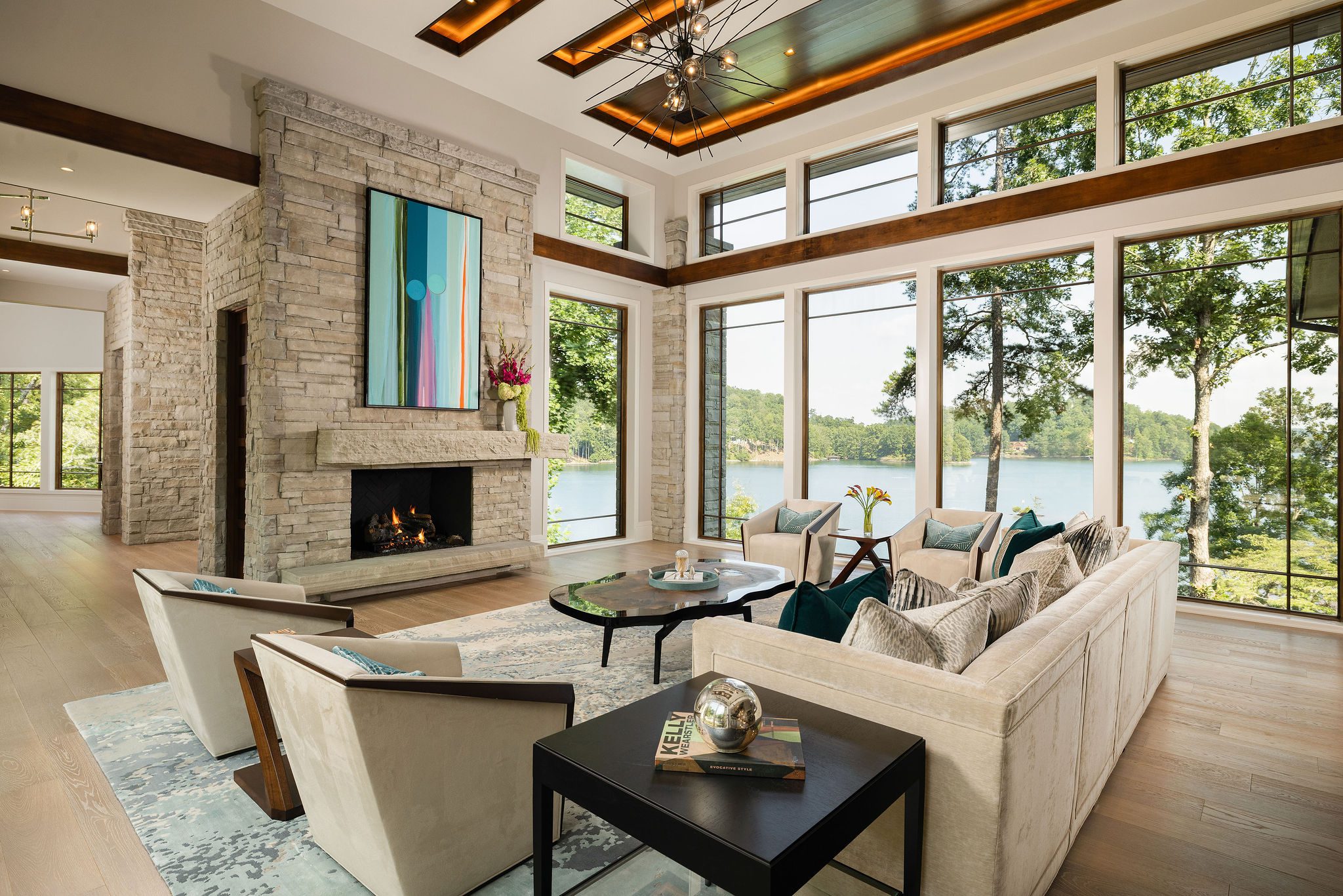 Gabriel Builders great room with stone fireplace and lake views