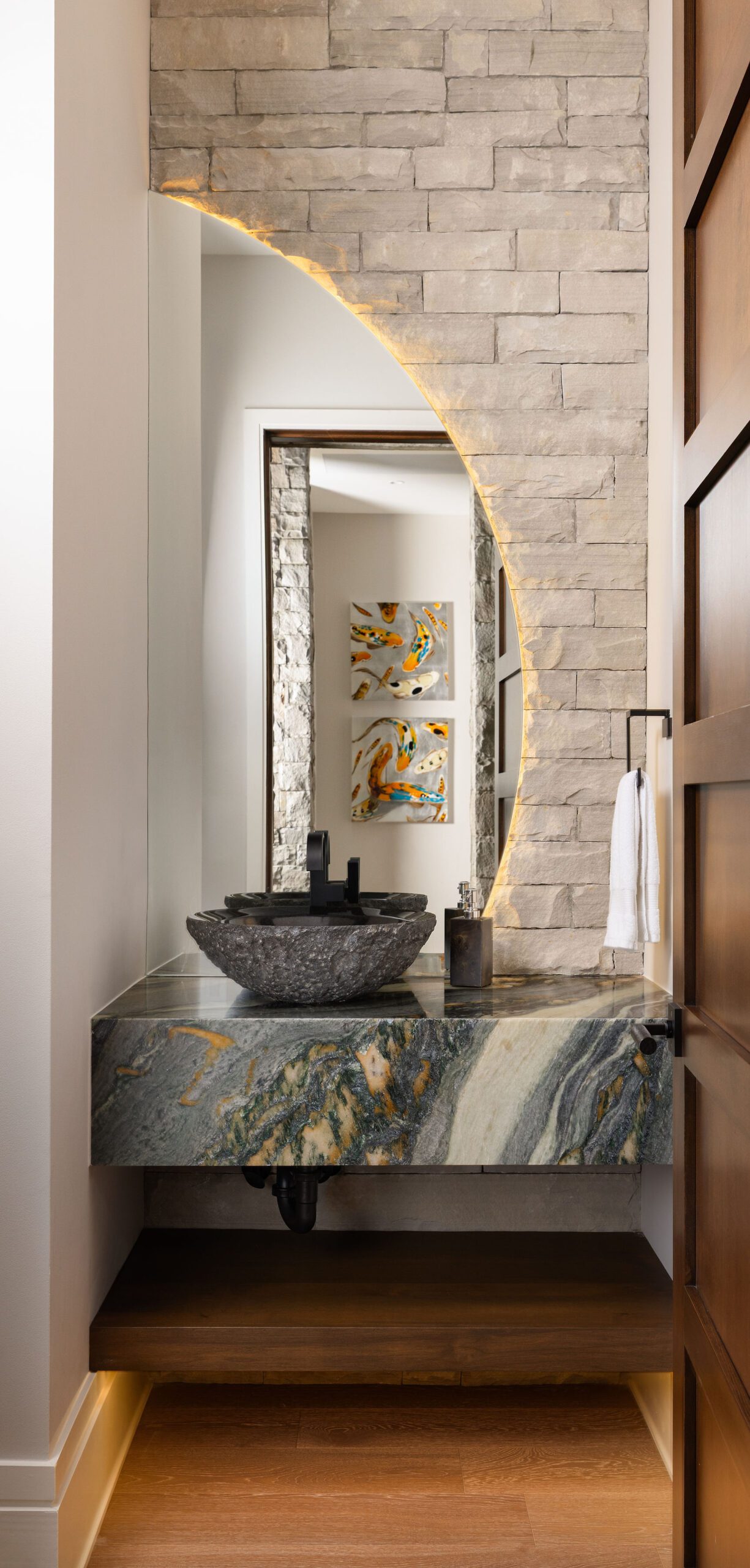 Luxury powder room with stone wall and vessel sink Gabriel Builders