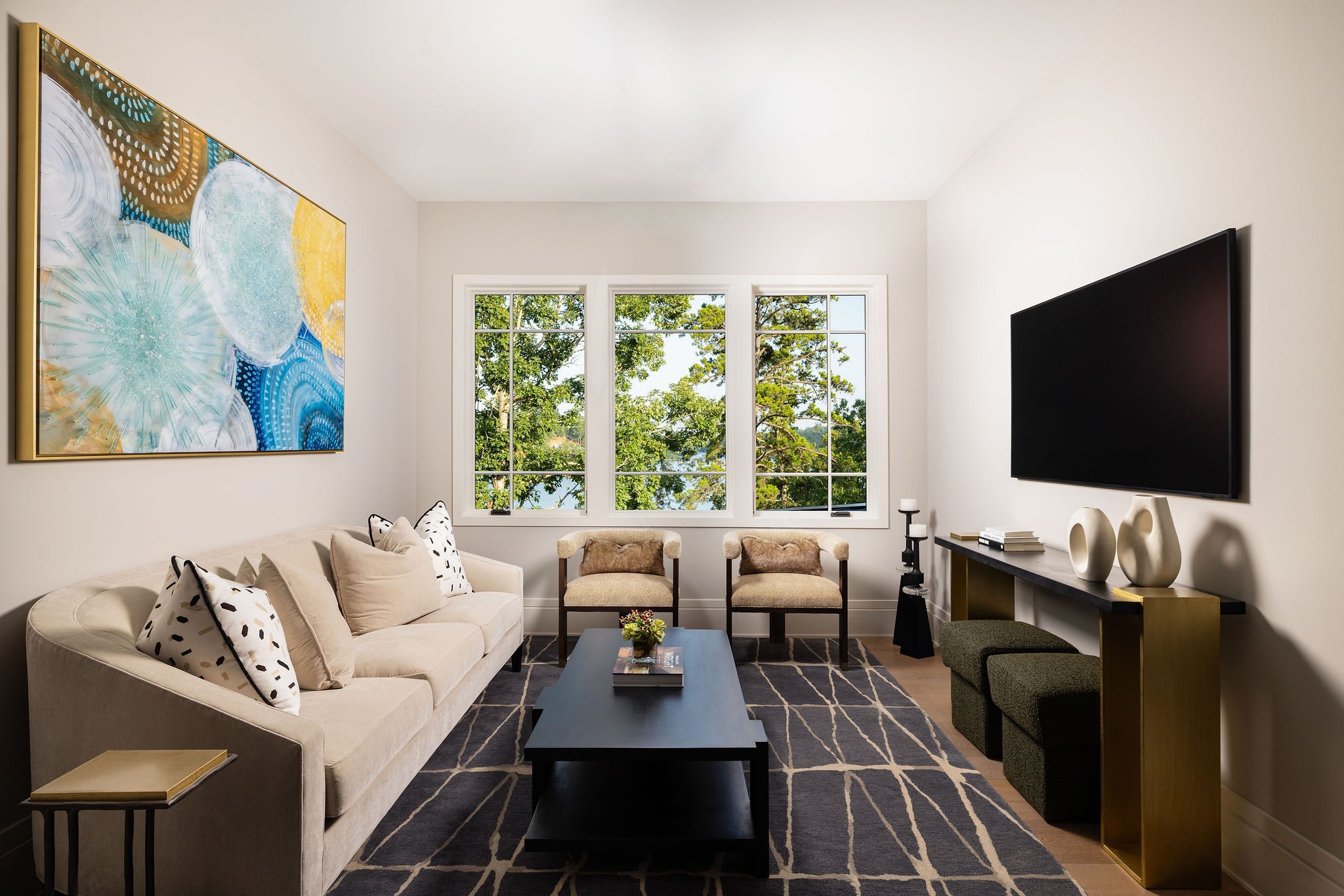 Modern sitting room with large window and lake view Gabriel Builders