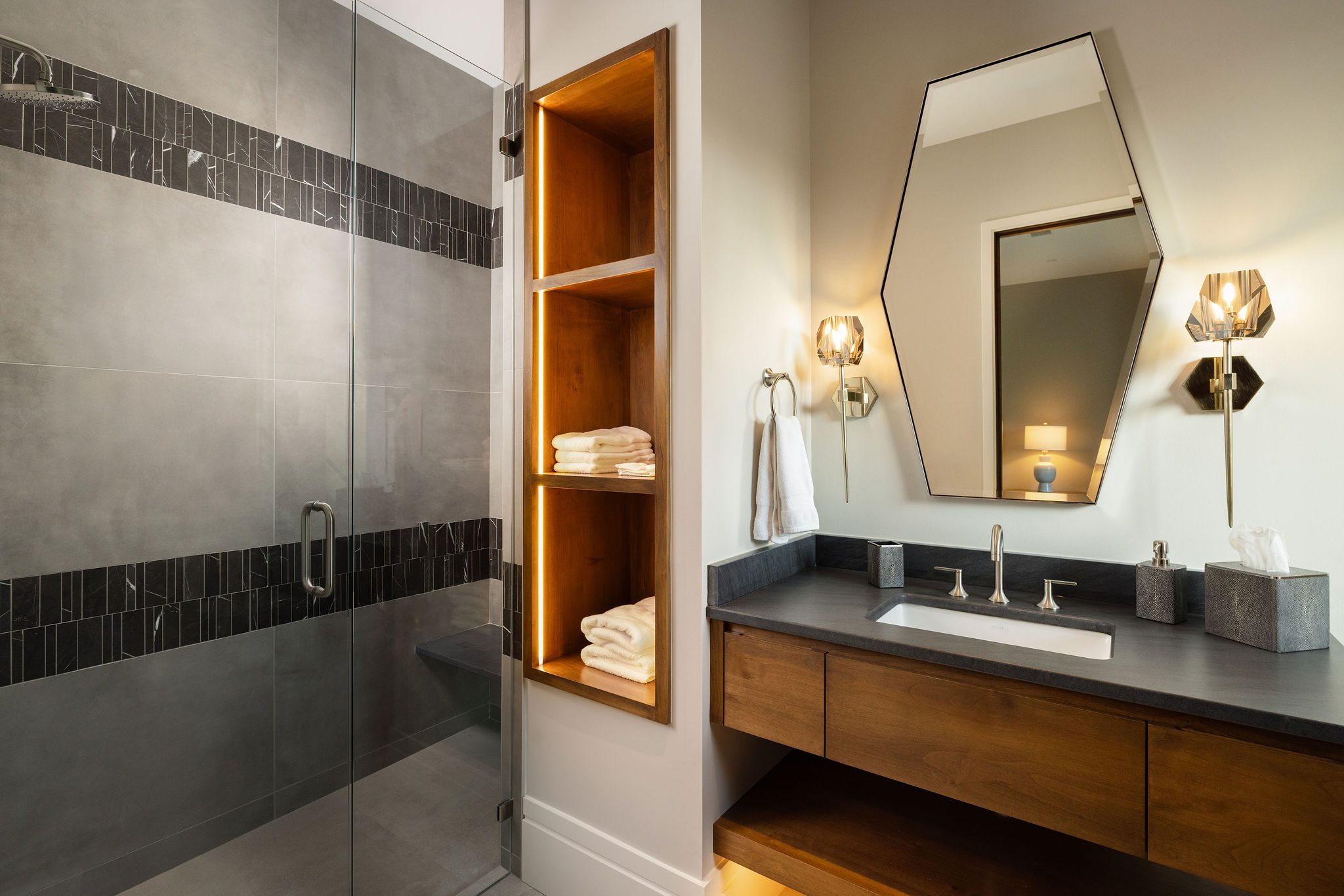 Guest bathroom with modern walk-in shower and wood vanity Gabriel Builders