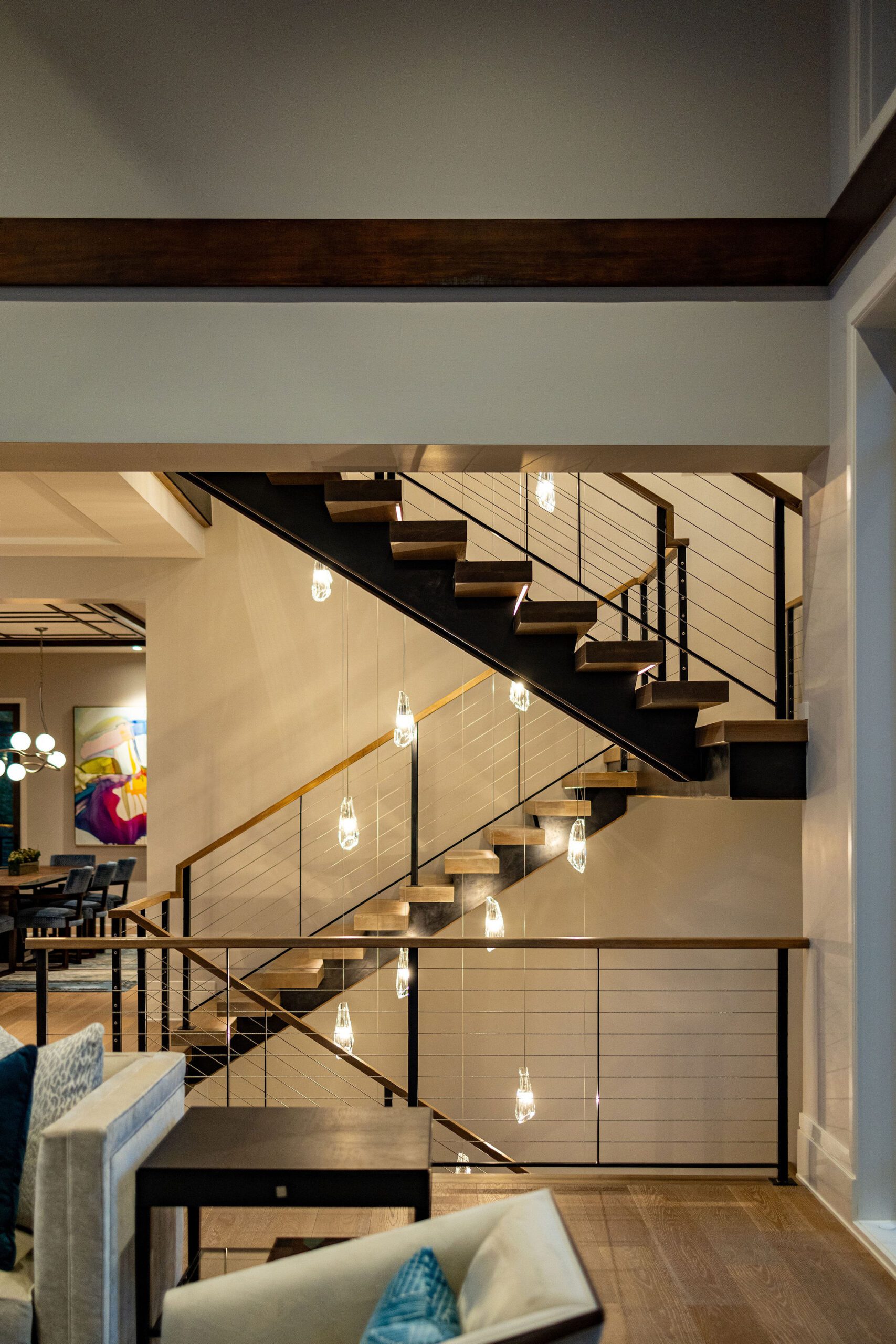 Modern staircase with cable railing in Gabriel Builders luxury home