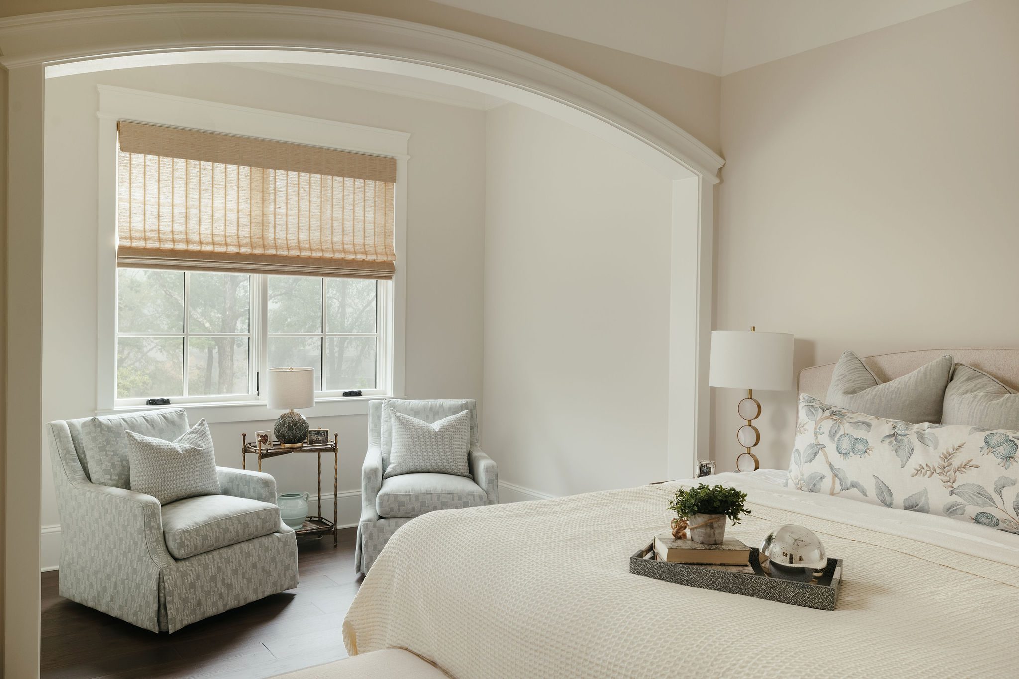 Bright guest bedroom with sitting area.