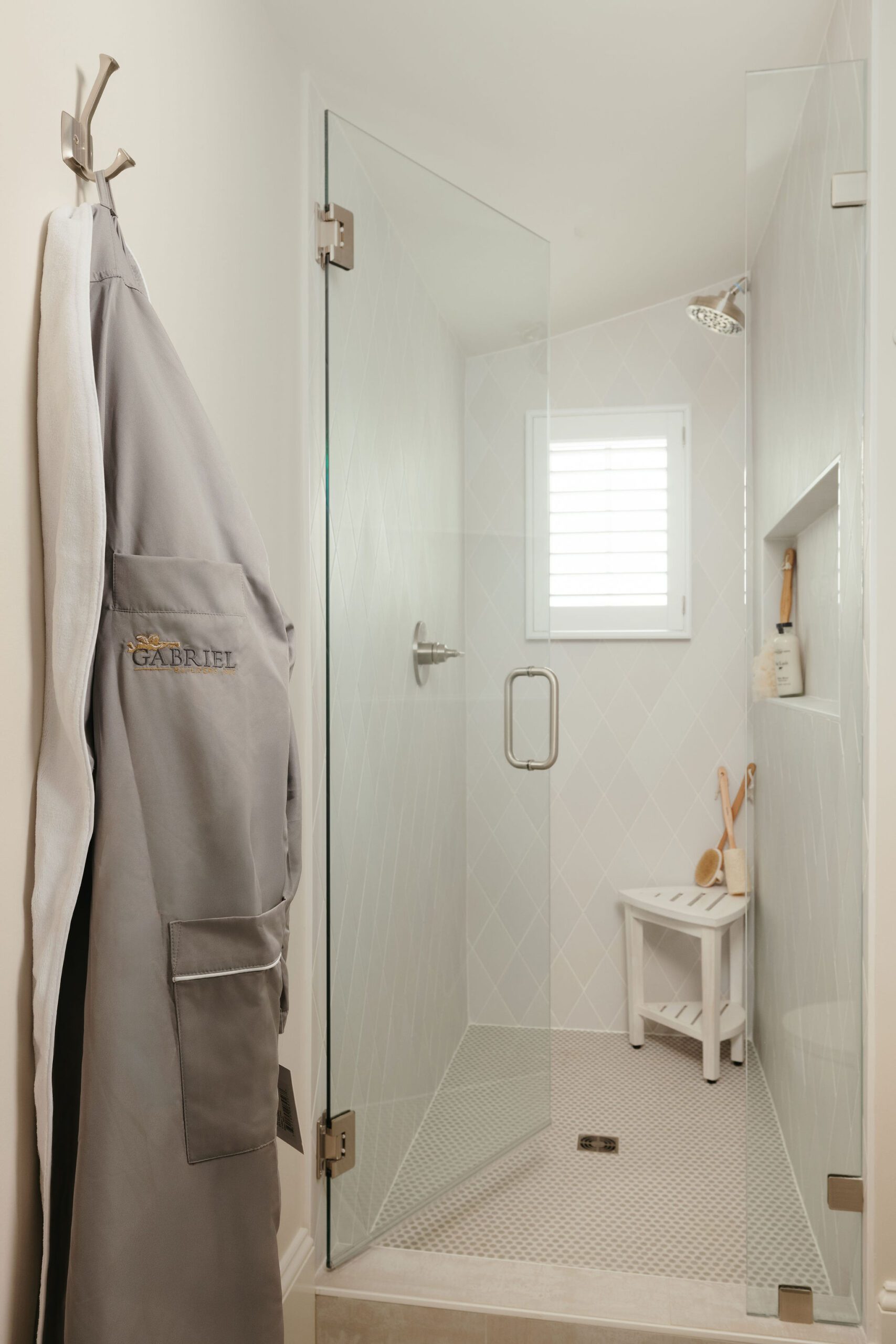 Frameless glass shower with tile surround