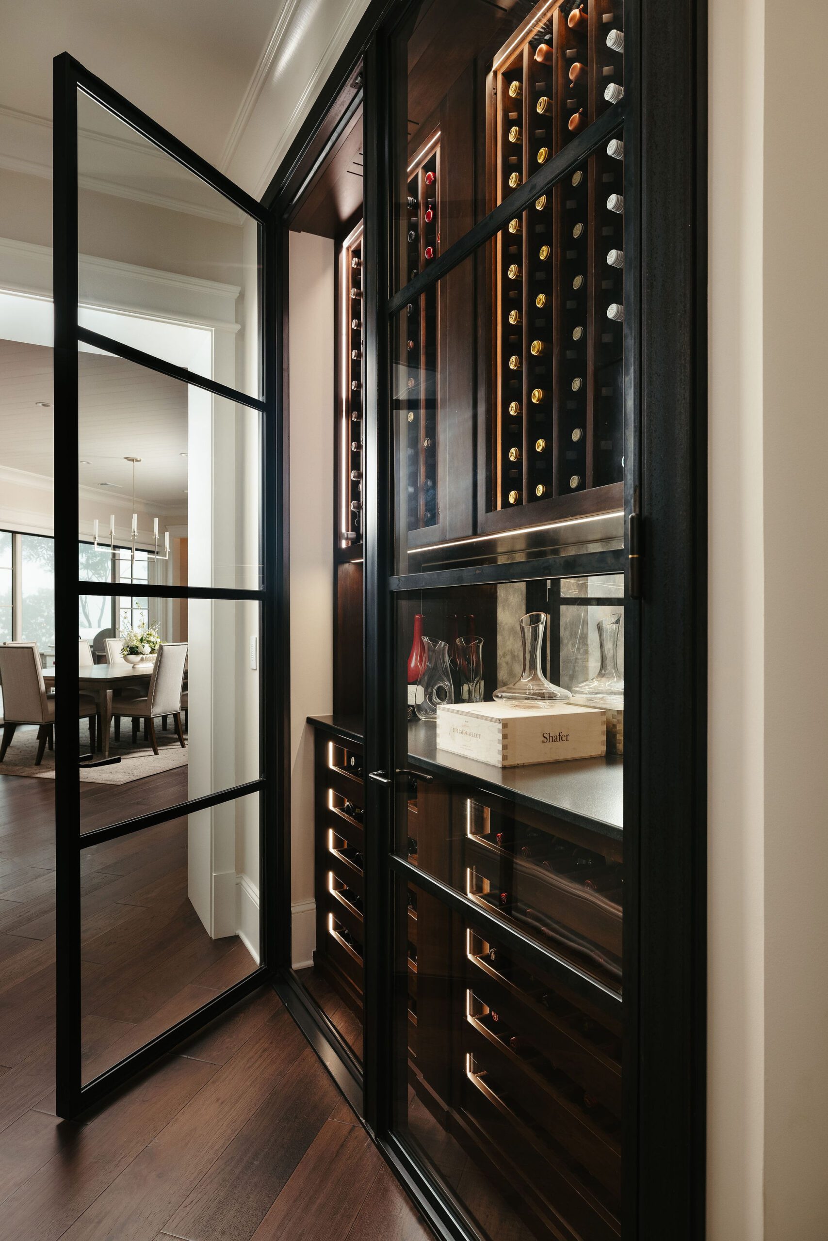 Wine cellar with dark wood cabinetry and display lighting