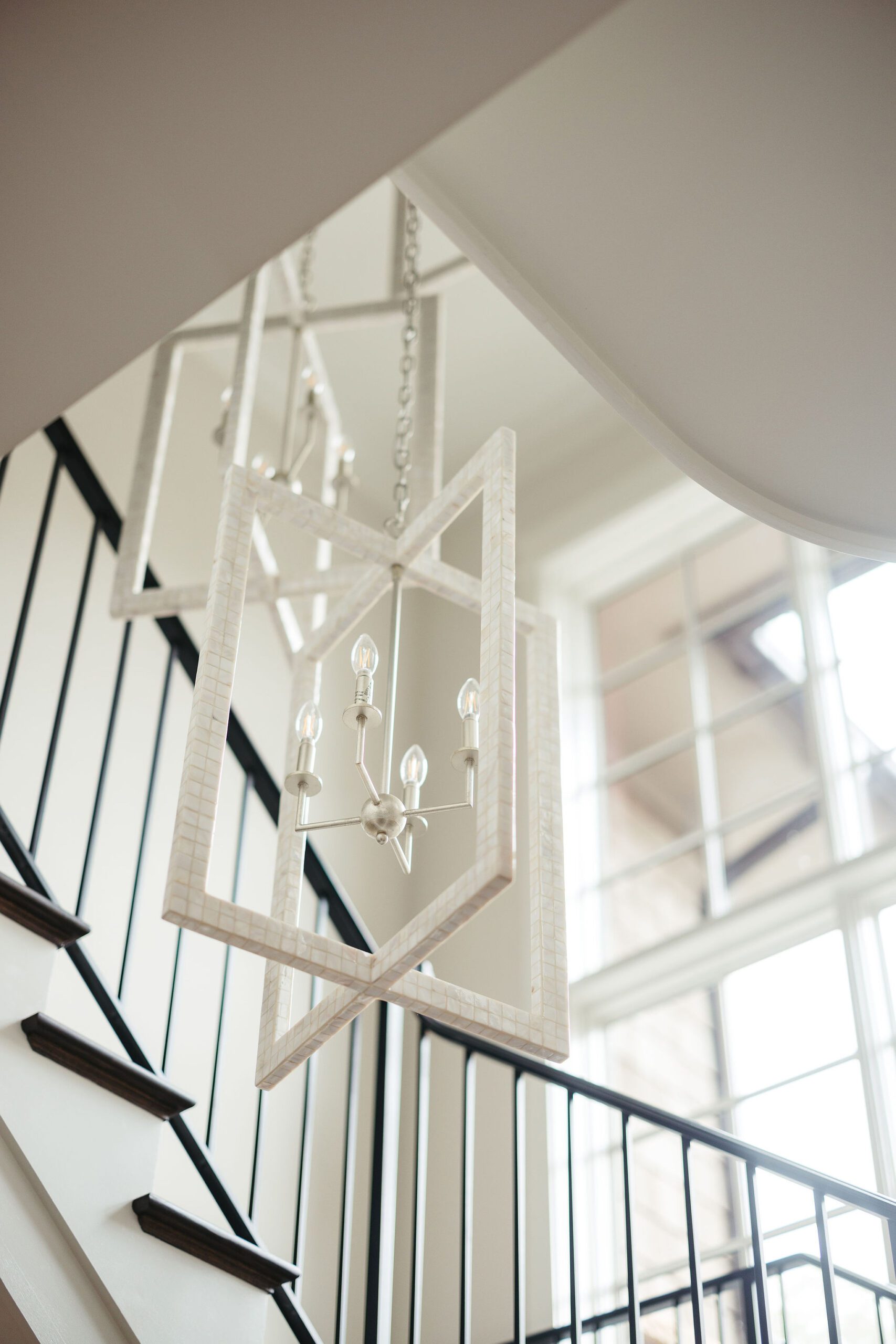 Custom light fixtures in luxury home stairwell
