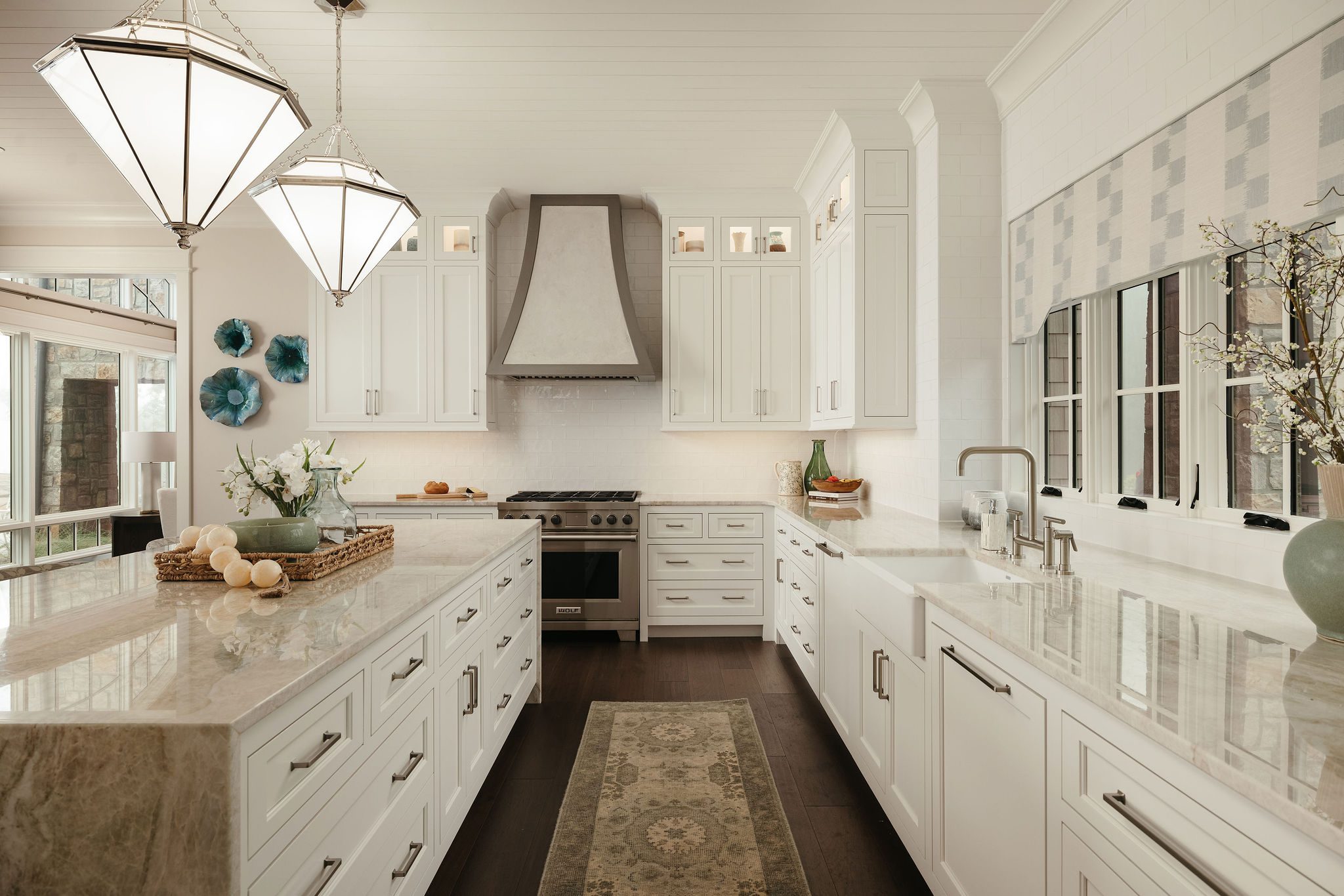 Custom kitchen with waterfall island and range hood