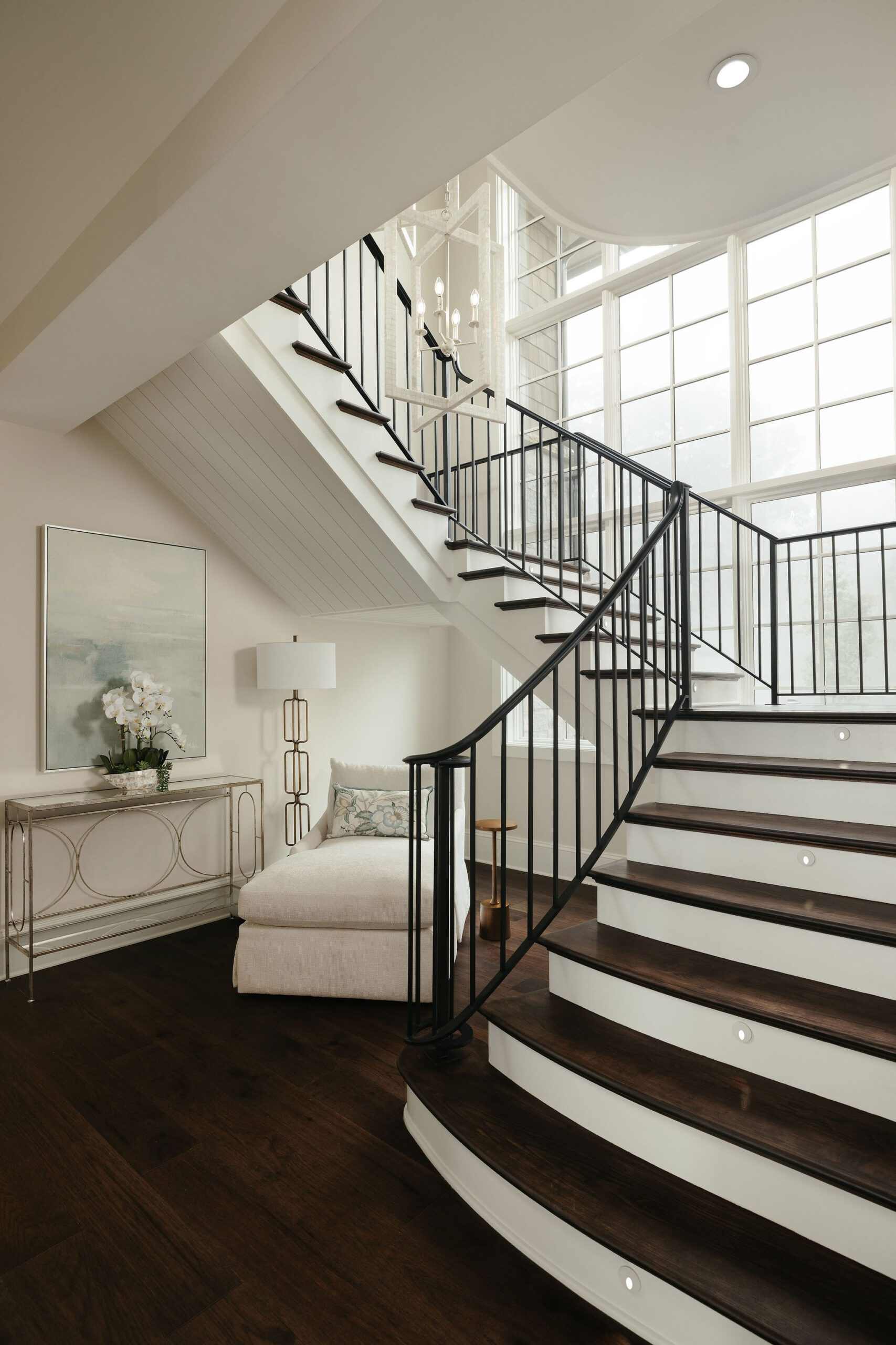 Custom staircase with iron railing and large window